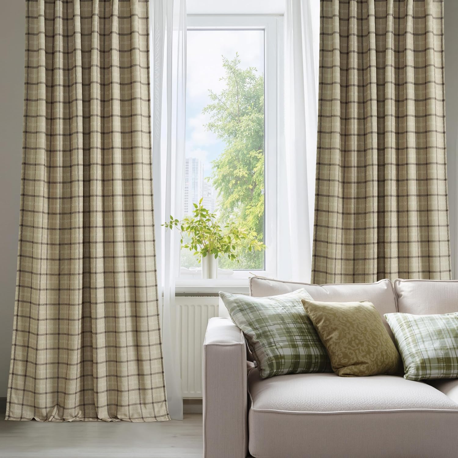 Full-length tan and brown plaid pleated thermal drapes elegantly hanging in a cozy living room.