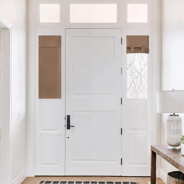 Tan fabric window treatments on white entry door. Features a flat panel and roman shade on sidelights.