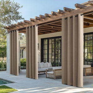 Tan outdoor grommet curtains hanging from a wooden pergola, providing privacy and shade for a patio area.