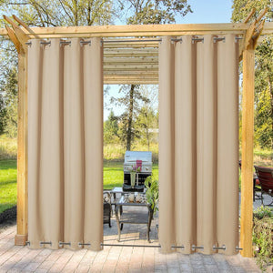 Tan outdoor privacy curtains with grommet tops hanging on a rod under a wooden pergola on a patio.