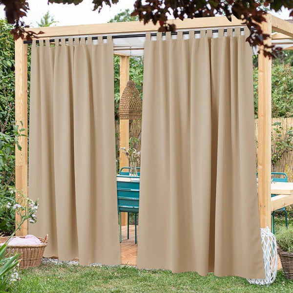 Tan outdoor tab top curtains providing shade and privacy on a garden pergola.