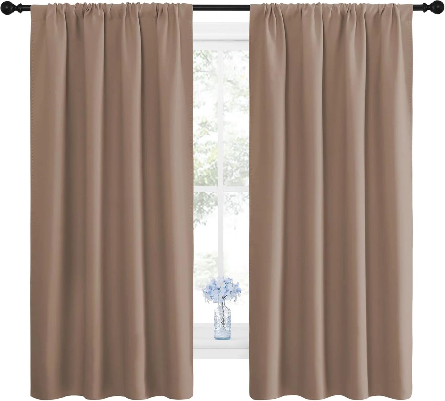 Pair of tan rod pocket thermal blackout curtains hanging on a black rod.