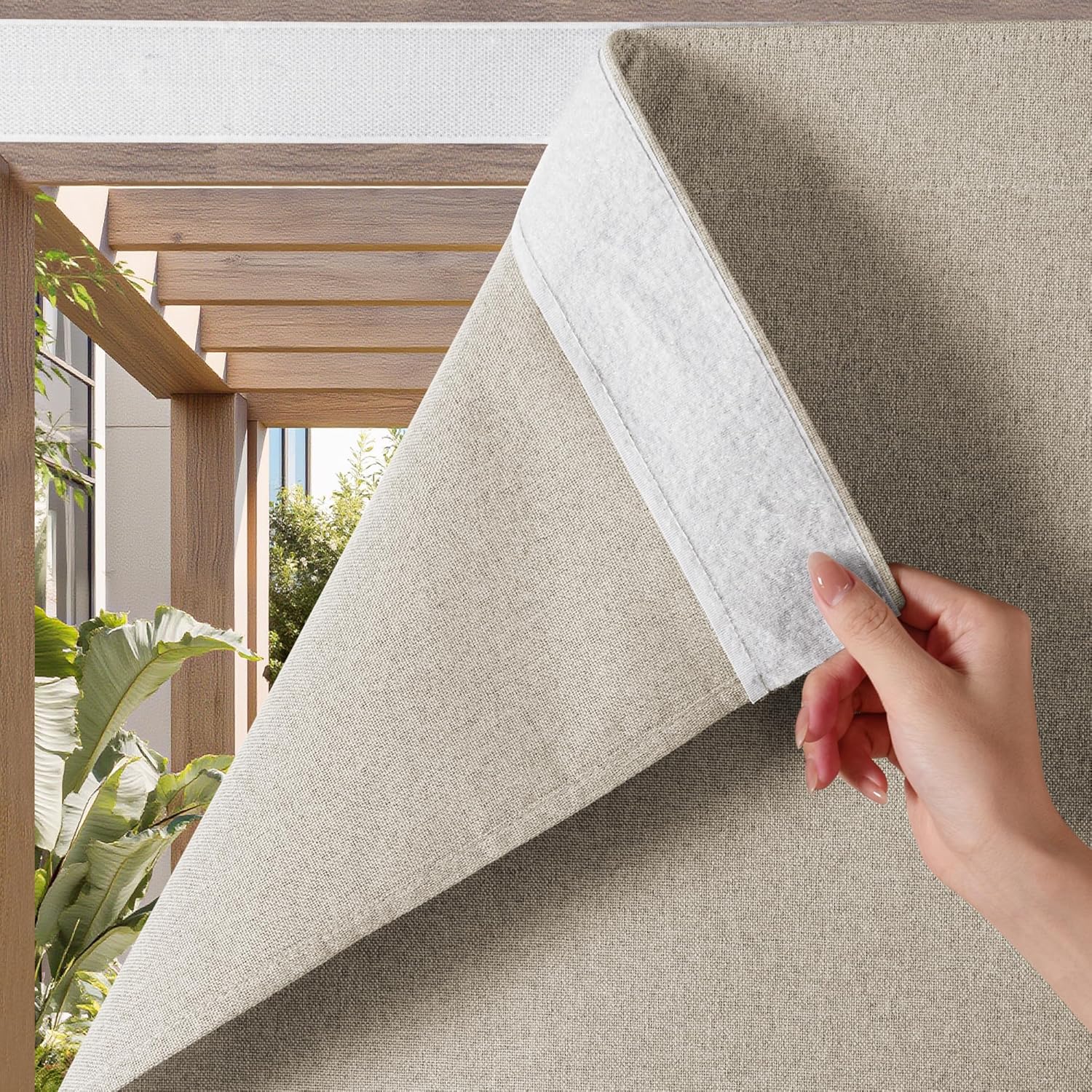 Tan textured window shade with white velcro attachment, peeled back by a hand.
