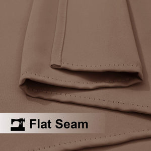 Close up of a taupe blackout curtain fabric showing a neatly stitched flat seam construction.