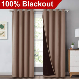 Pair of taupe brown blackout curtains with silver grommet tops. Dark lining visible, ensuring 100% light blockage.