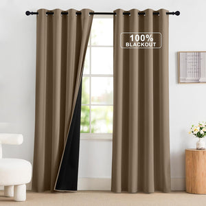 Taupe blackout curtains with grommet tops on a black rod, one pulled back to reveal black lining.