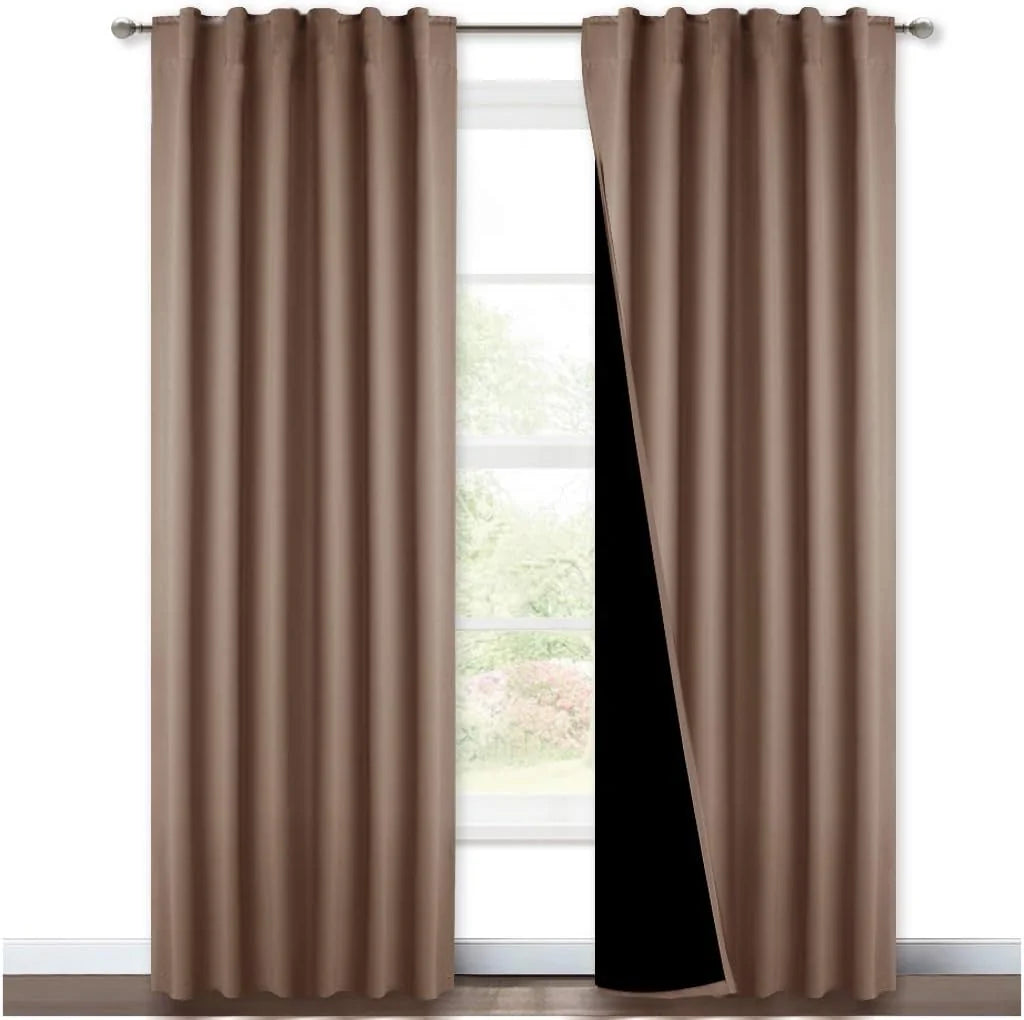 Taupe blackout curtains with rod pocket top hanging on a silver curtain rod