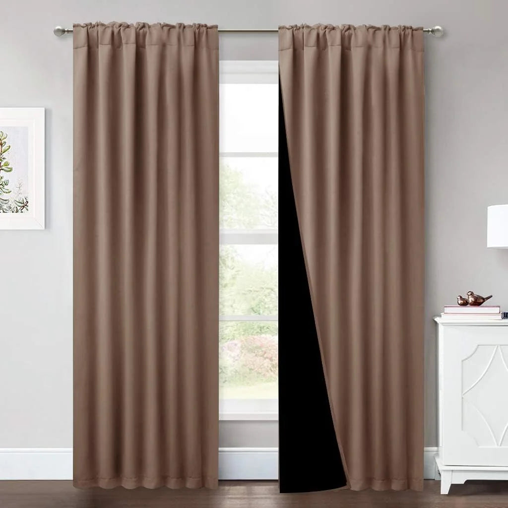 Taupe blackout curtains with rod pocket top hanging in a bright modern room