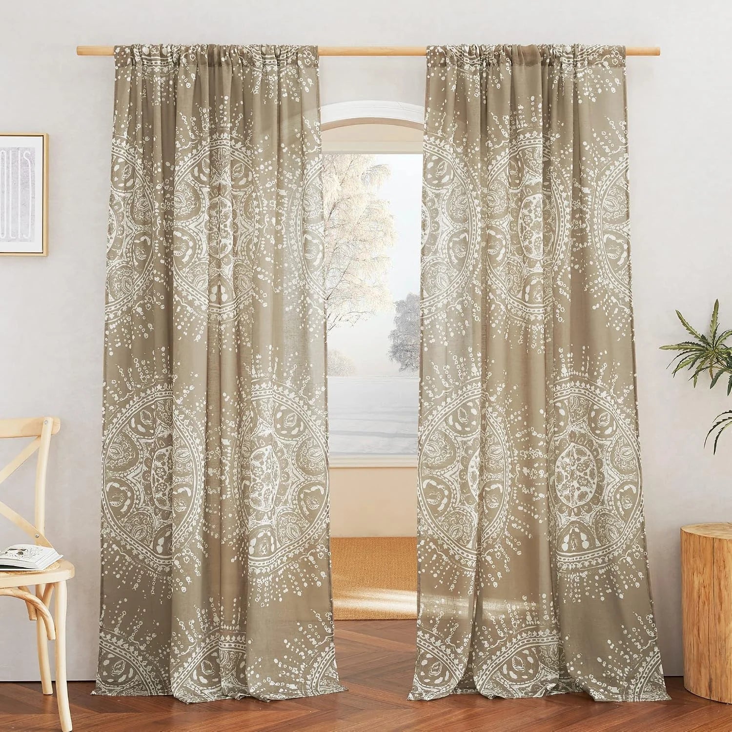 Taupe boho printed curtains with white medallion pattern hanging on a wooden rod