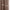 Close-up of taupe brown blackout curtain, highlighting its smooth front and a textured back with diagonal weave.