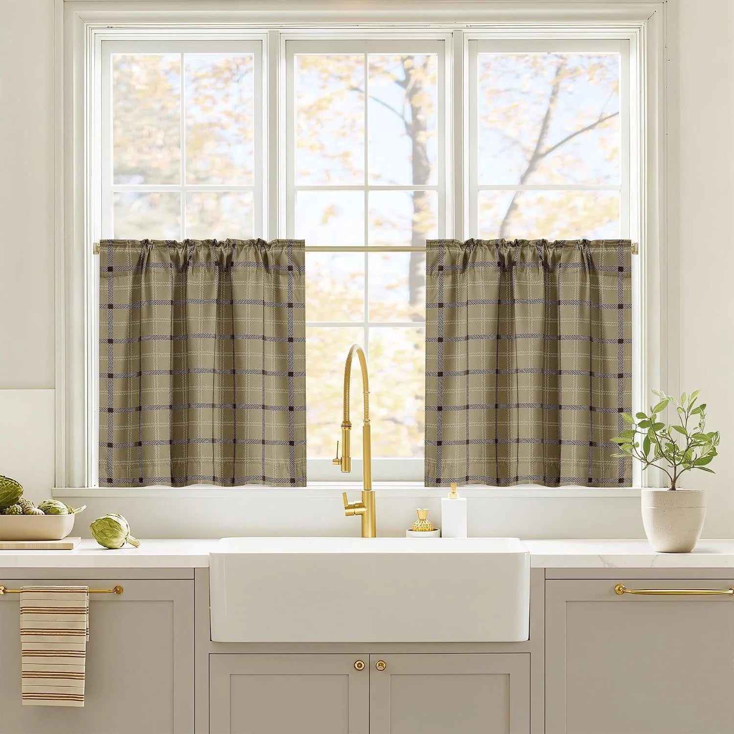 Taupe plaid tier curtains on a white kitchen window above a farmhouse sink