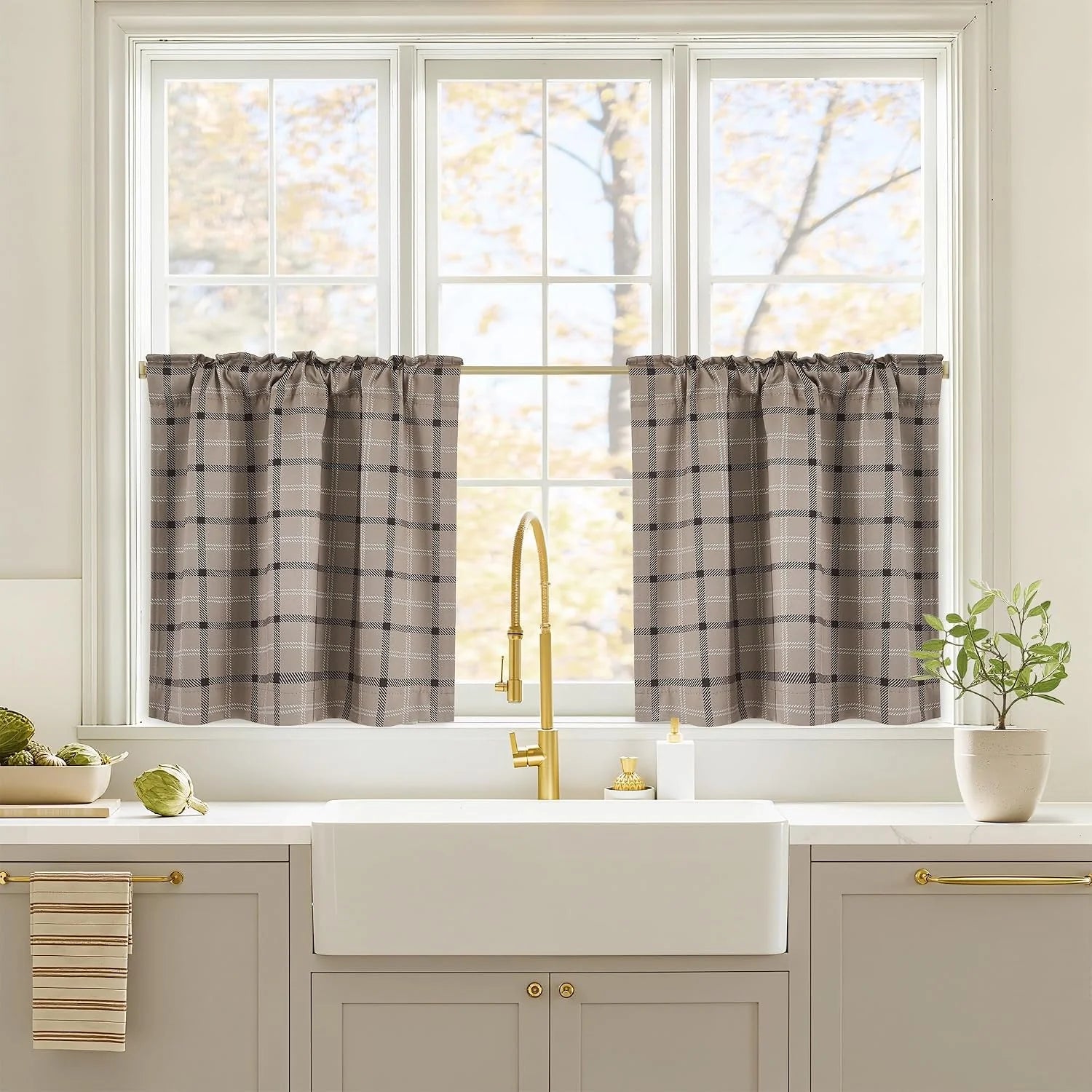 Taupe plaid tier curtains on a white kitchen window above a farmhouse sink