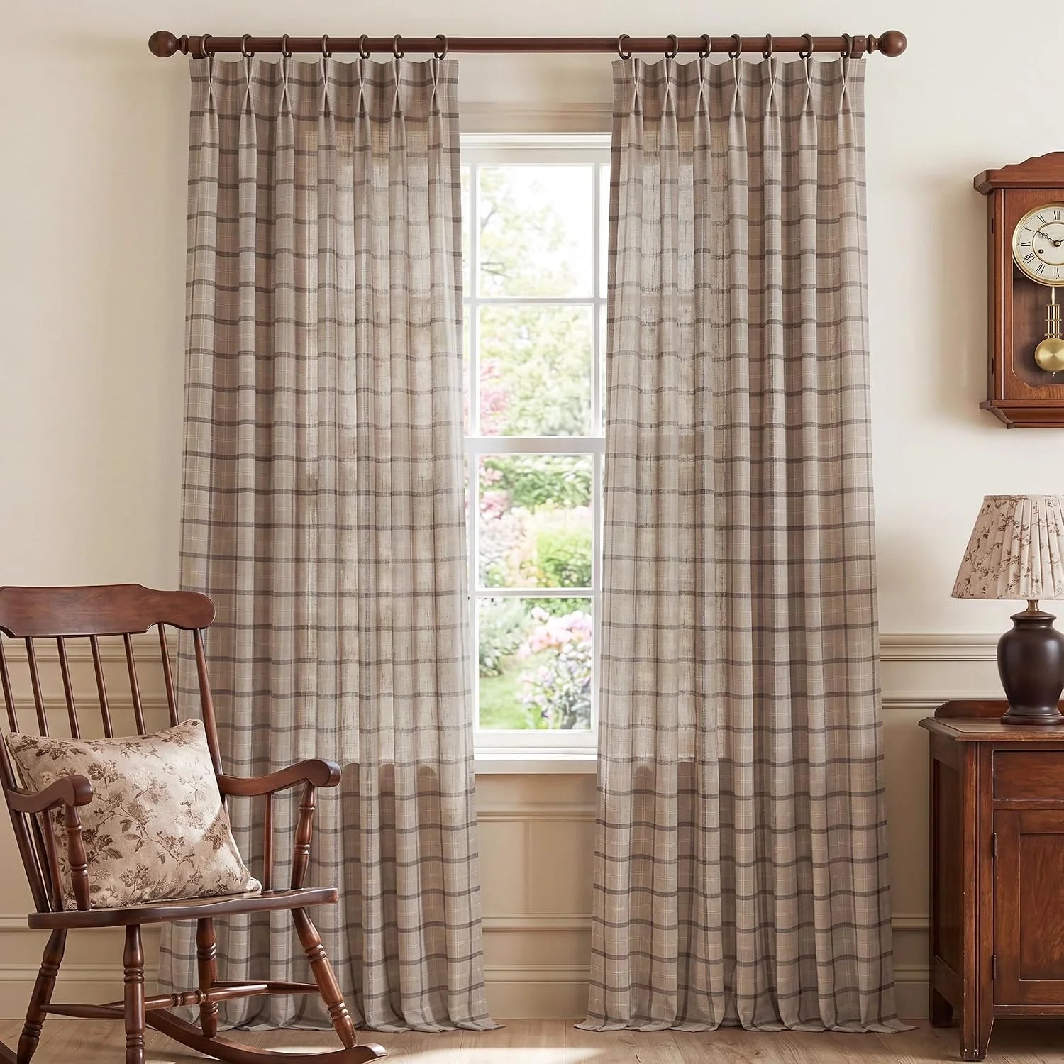 Taupe plaid sheer curtains on a wooden rod in a traditional living room