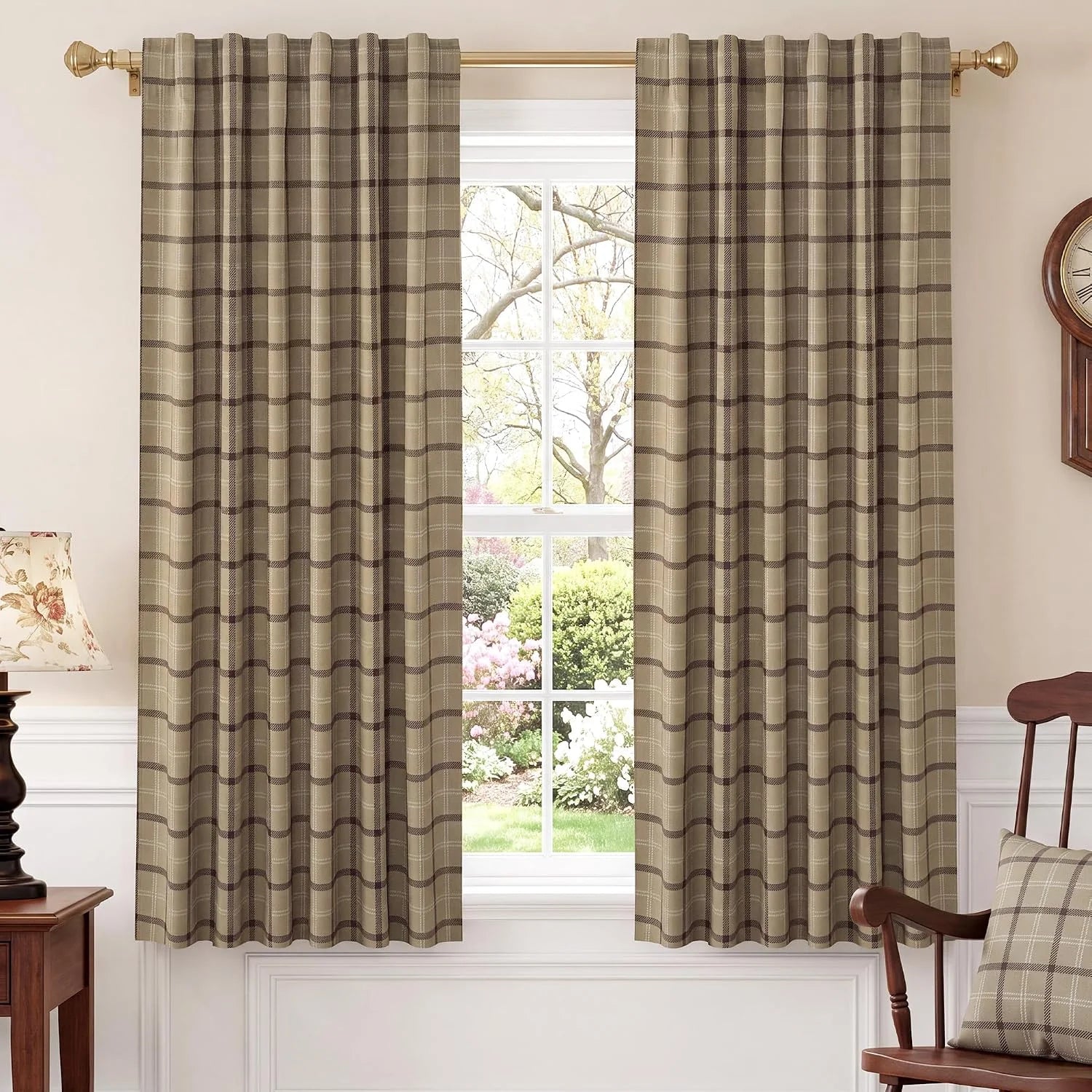 Taupe plaid curtains on a brass rod in a traditional room with bright window