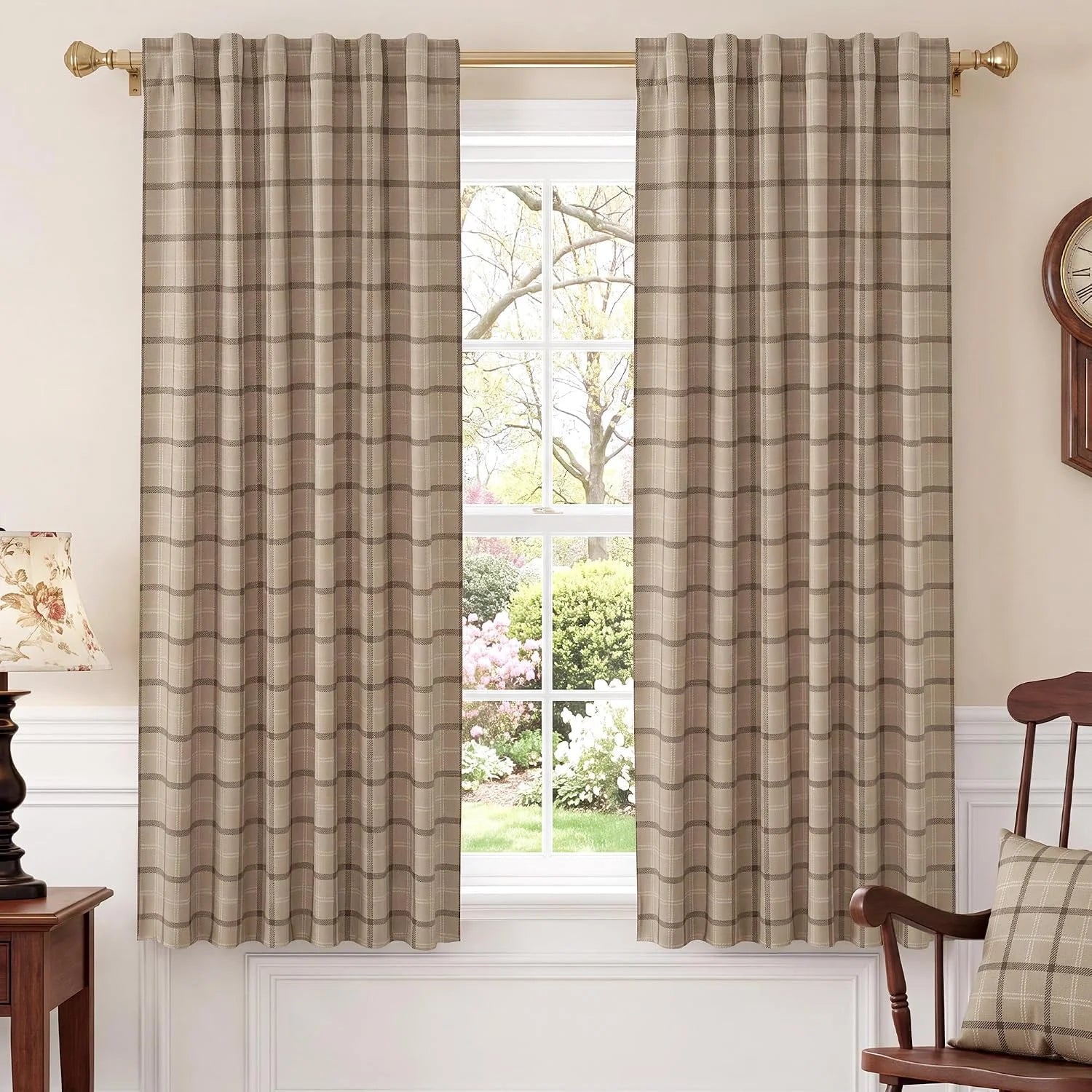 Taupe plaid curtains on a brass rod in a traditional room with a bright window
