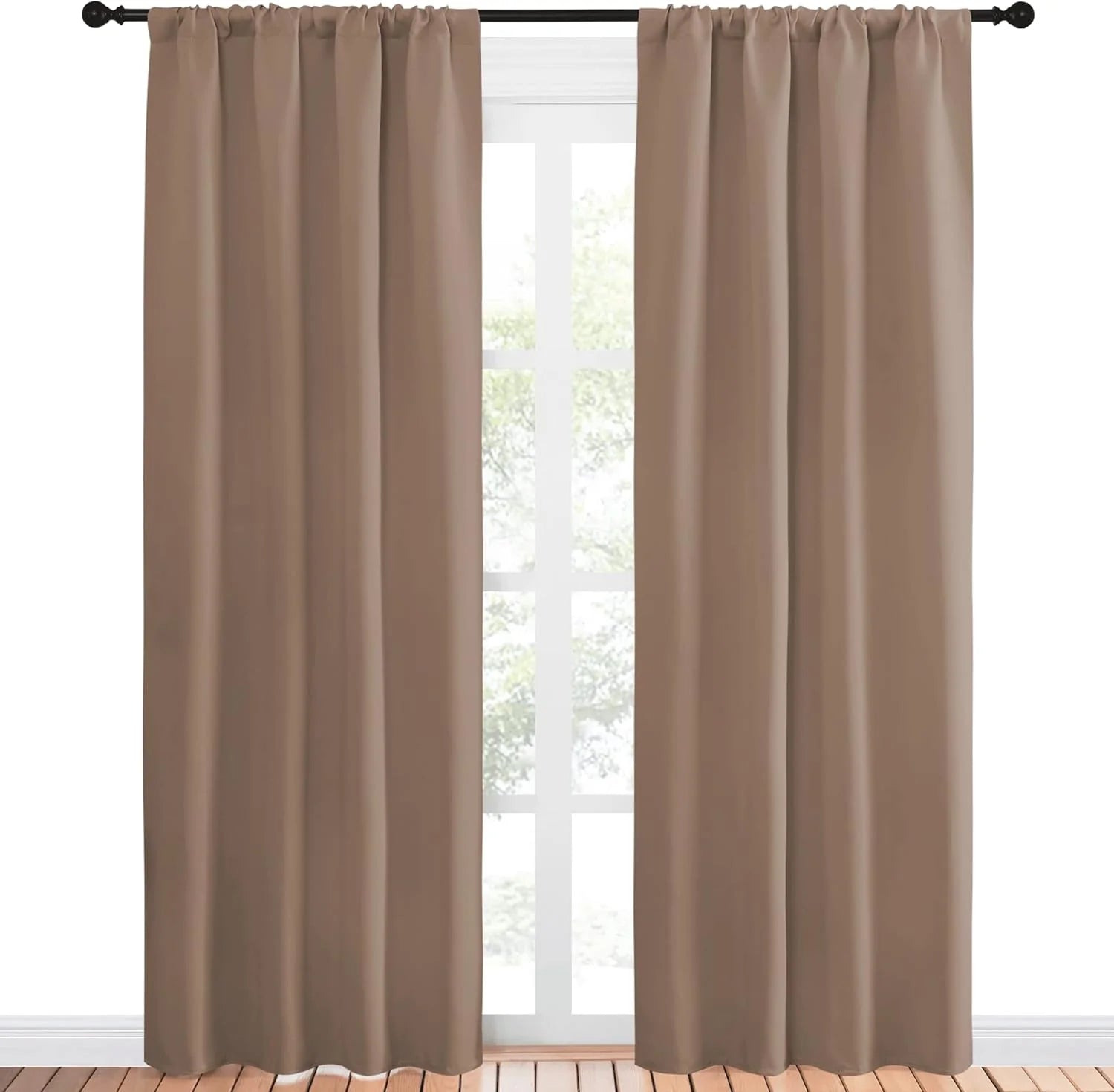 Taupe brown solid blackout curtains with rod pocket top on a black rod above wooden floor.