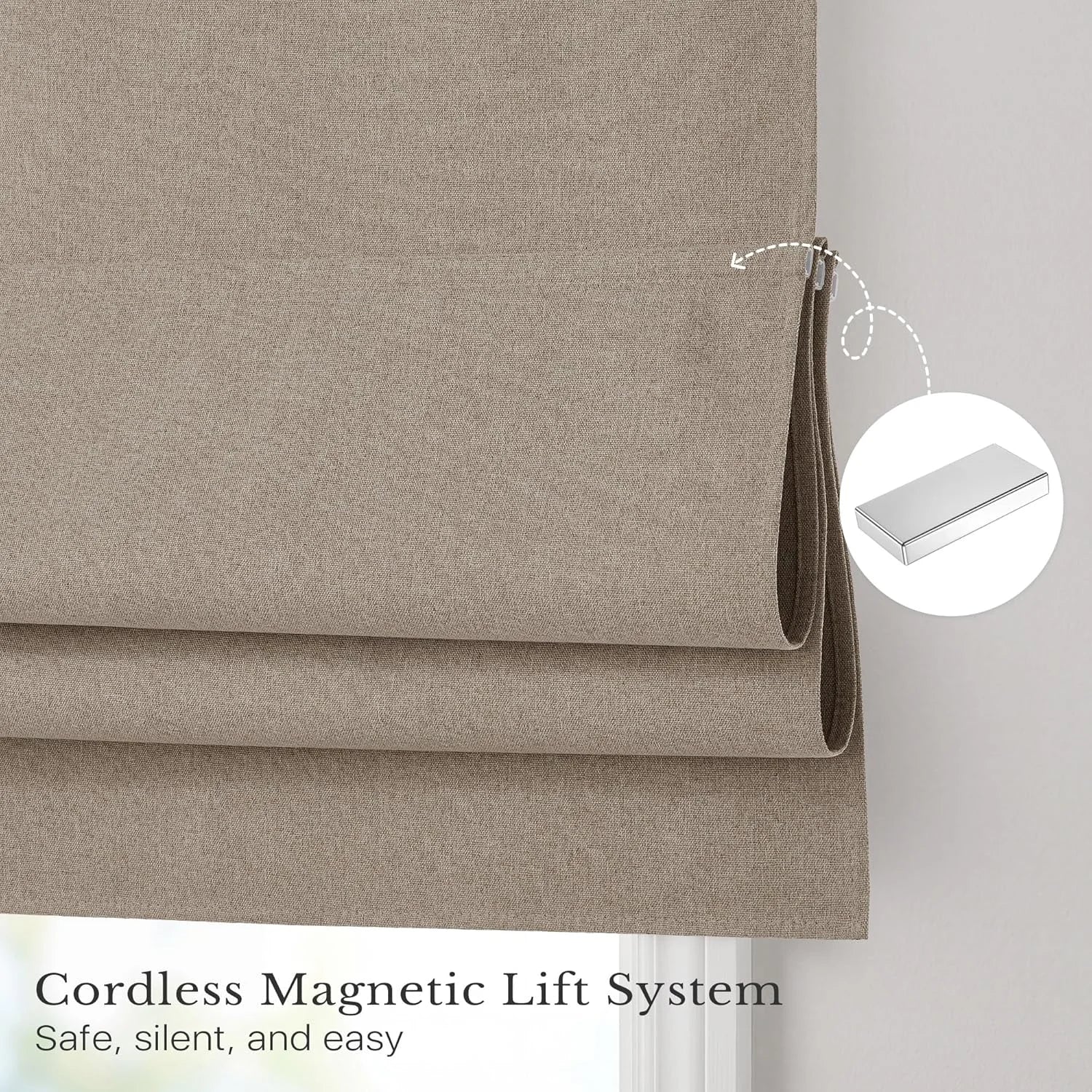 Taupe fabric roman shades with a cordless magnetic lift system, showing folded fabric and a silver magnetic bar.