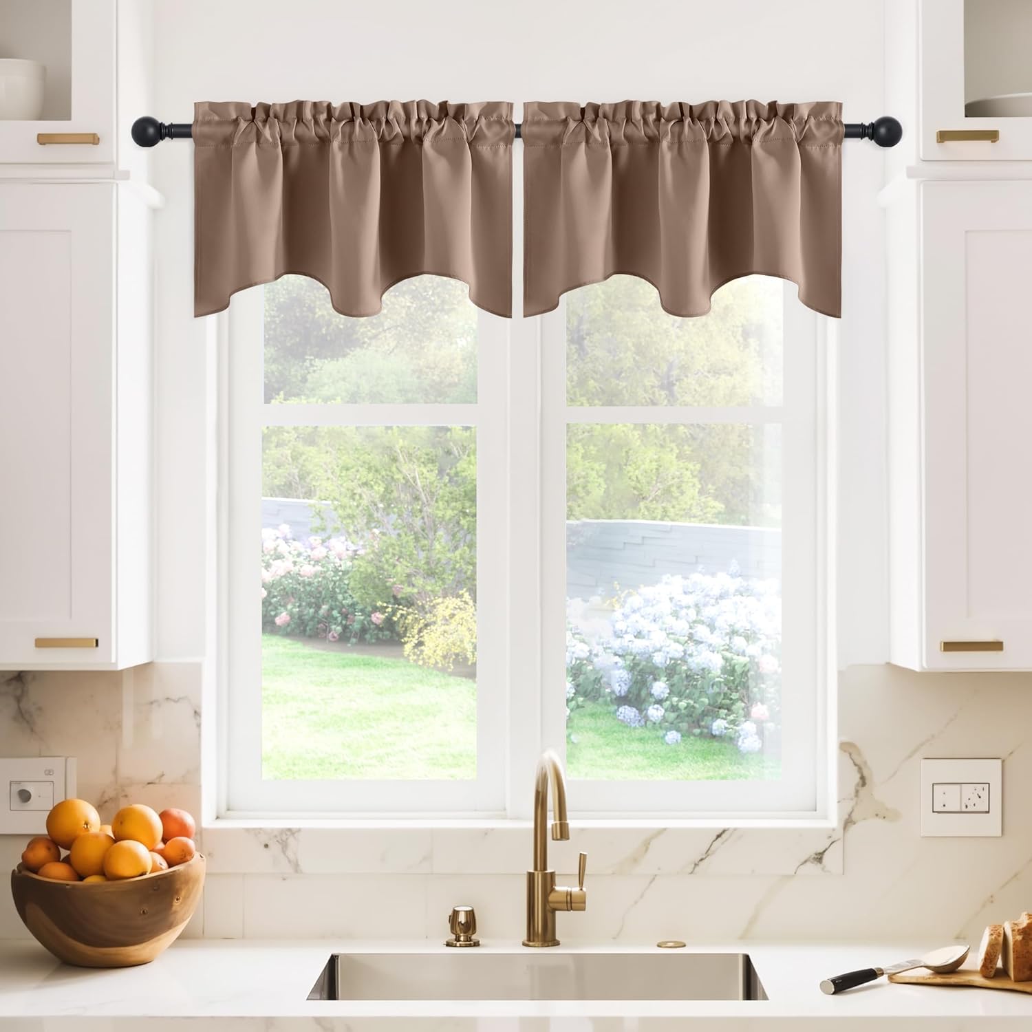 Smooth taupe valance curtain with a decorative scalloped edge, adorning a kitchen window above a sink.