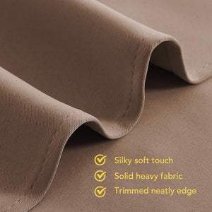 Close-up of folded taupe-brown fabric showing its silky, solid texture and neatly stitched edge.