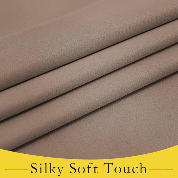 Close-up of taupe silky soft woven fabric folded neatly, revealing smooth texture and gentle drape.