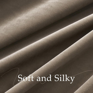 Detailed view of a soft, silky taupe velvet fabric, displaying its plush texture and flowing drape.