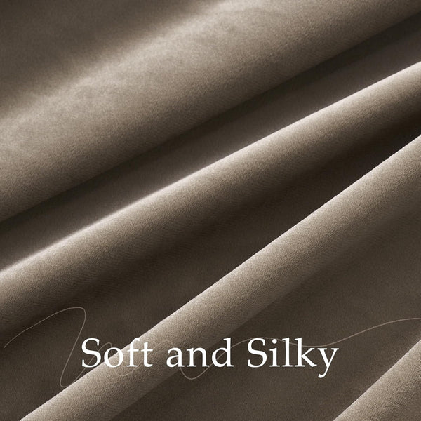 Detailed view of a soft, silky taupe velvet fabric, displaying its plush texture and flowing drape.