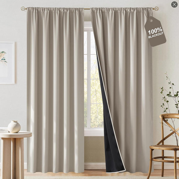 Taupe solid blackout curtains with a gathered rod pocket top. One panel open revealing dark black lining.