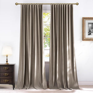 Elegant taupe velvet curtains with an inherent pleated style hanging on a decorative brass rod.
