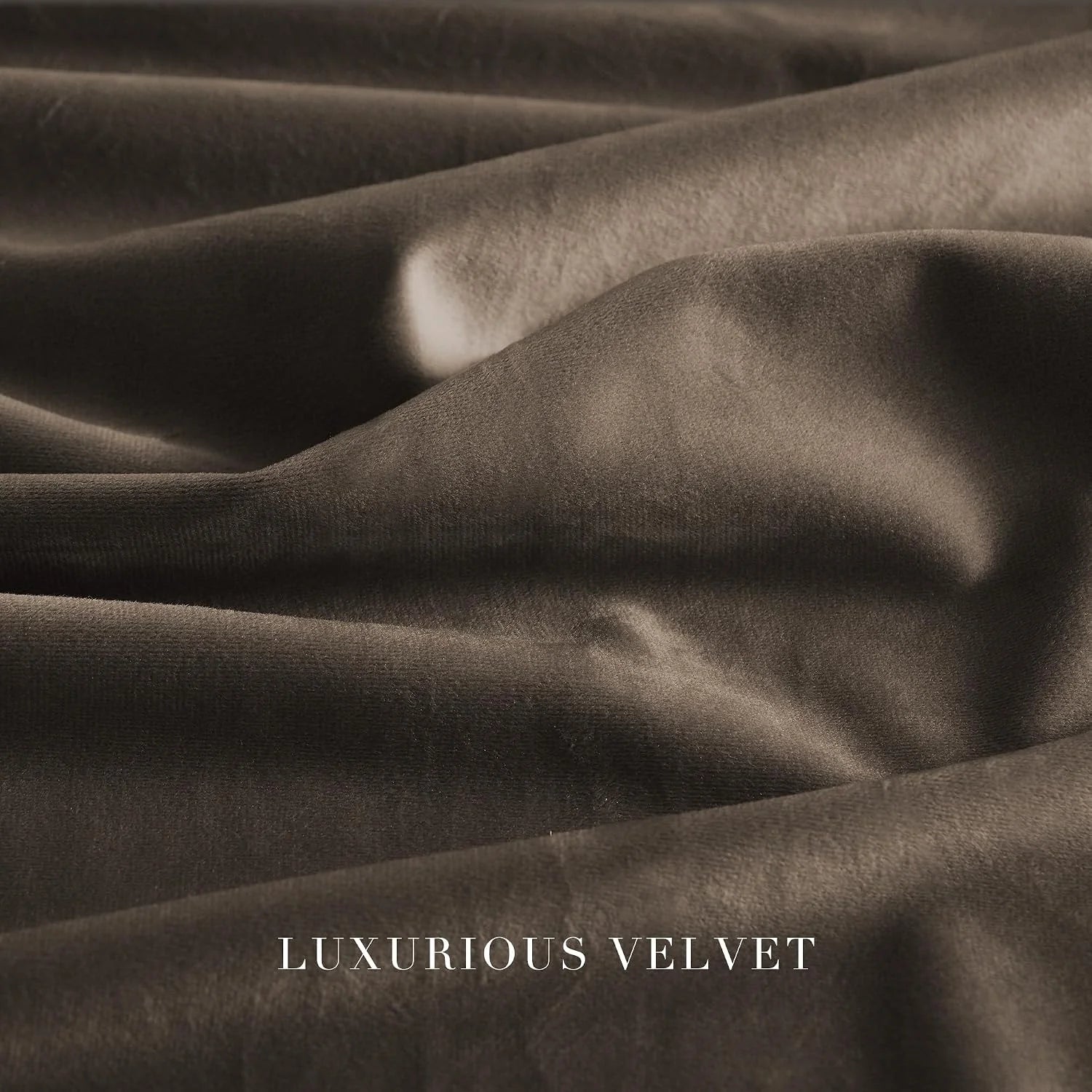 Close-up of soft taupe velvet fabric with rich folds and a subtle sheen