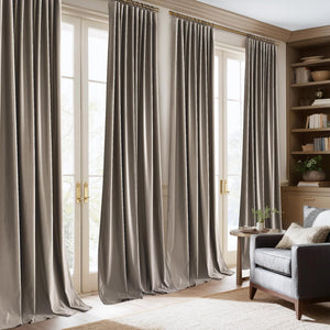 Taupe velvet ring top curtains elegantly hang over french doors, pooling gracefully on the floor.
