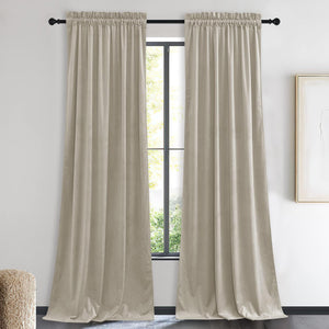 Pair of taupe velvet blackout curtains with gathered rod pocket top hanging in a modern room.
