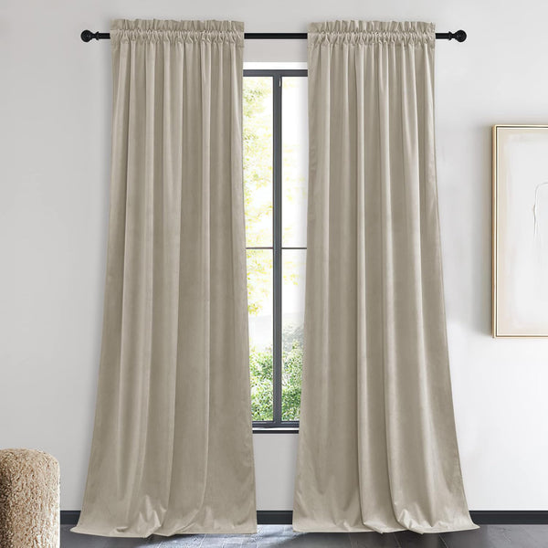 Pair of taupe velvet blackout curtains with gathered rod pocket top hanging in a modern room.