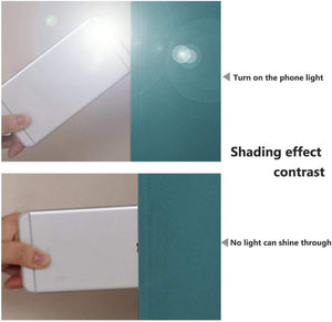 Teal blackout fabric blocks a phone flashlight. No light passes through, confirming its excellent light blocking.