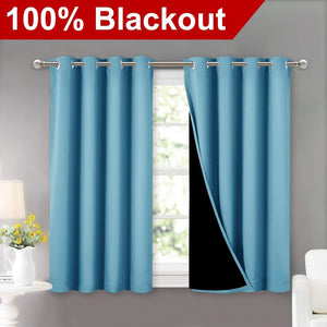 Teal blue blackout curtains with silver grommets over a window. One panel reveals black lining.