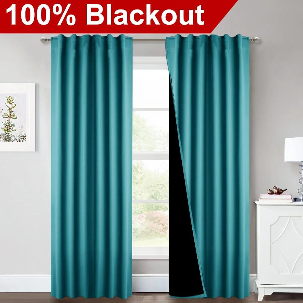 Teal blackout curtain panels on a silver rod in a bright modern room window