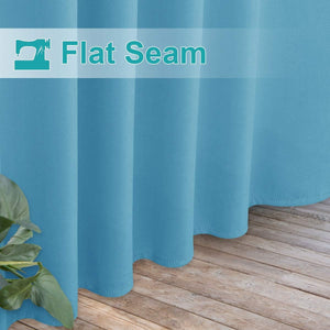 Vibrant teal blue curtain with flat seam detail and neatly stitched hem, draping onto a wooden floor.