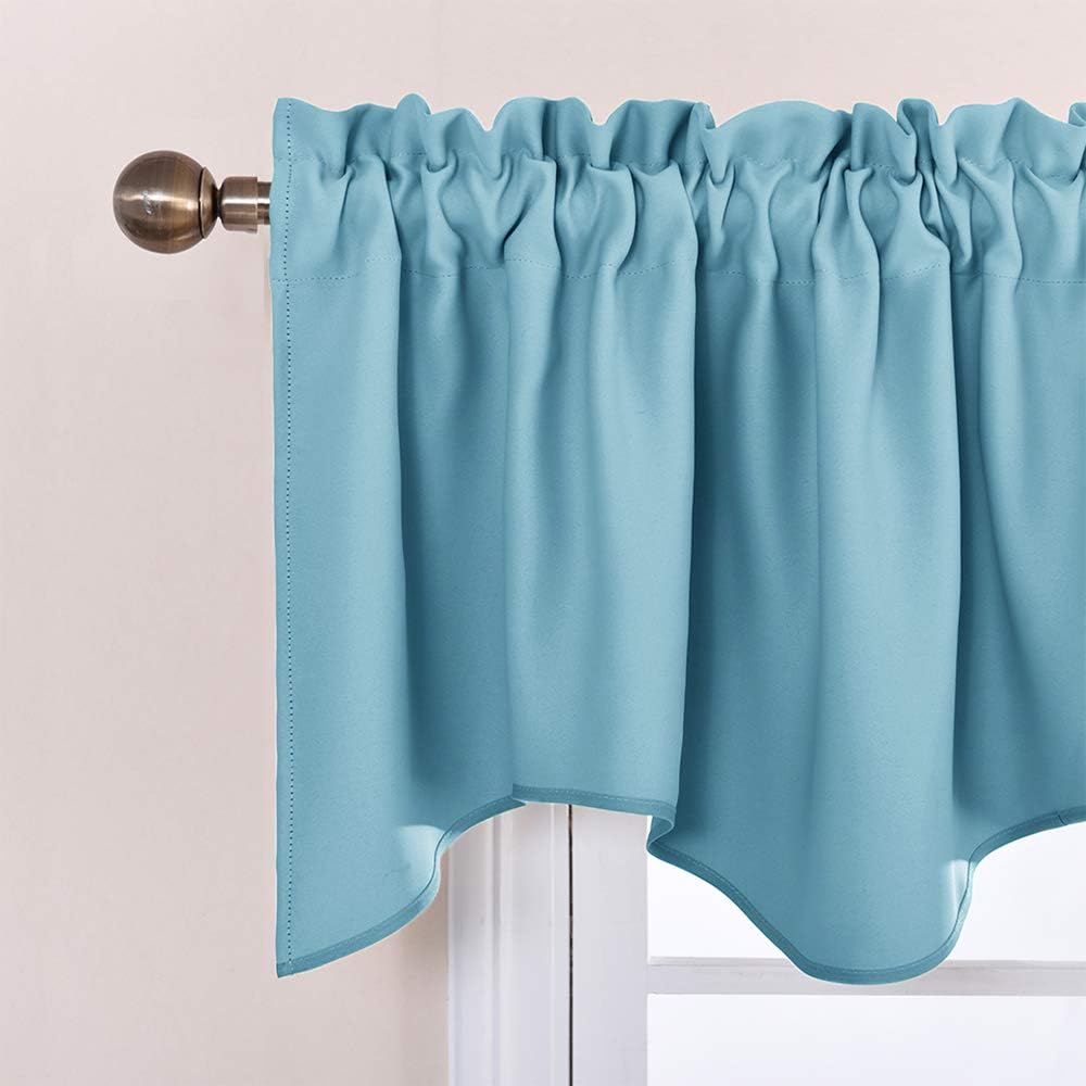 Close-up of a teal blue window valance featuring a ruffled rod pocket and elegant scalloped trim.