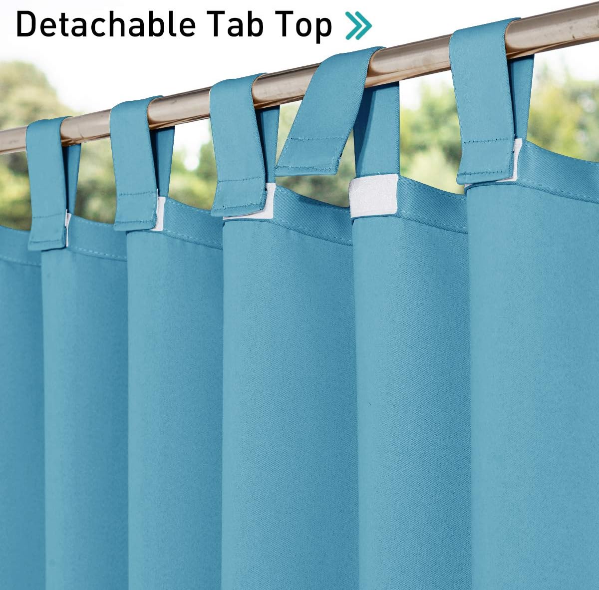 Close-up of vibrant teal curtains featuring a functional detachable tab top design, hanging on a metal rod.