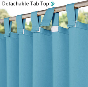 Close-up of vibrant teal curtains featuring a functional detachable tab top design, hanging on a metal rod.