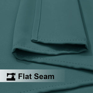 Close-up of teal woven fabric highlighting a precisely stitched flat seam. This detail shows quality and durability.