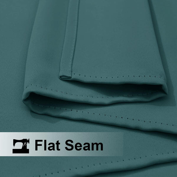 Close-up of teal woven fabric highlighting a precisely stitched flat seam. This detail shows quality and durability.