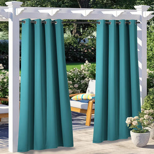 Teal outdoor grommet top curtains hanging from a white pergola in a sunny garden patio setting.