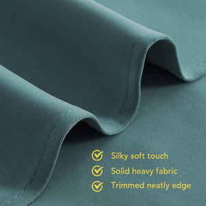 Close-up of teal, heavy fabric with a silky-soft texture and neatly trimmed stitched edge detail.