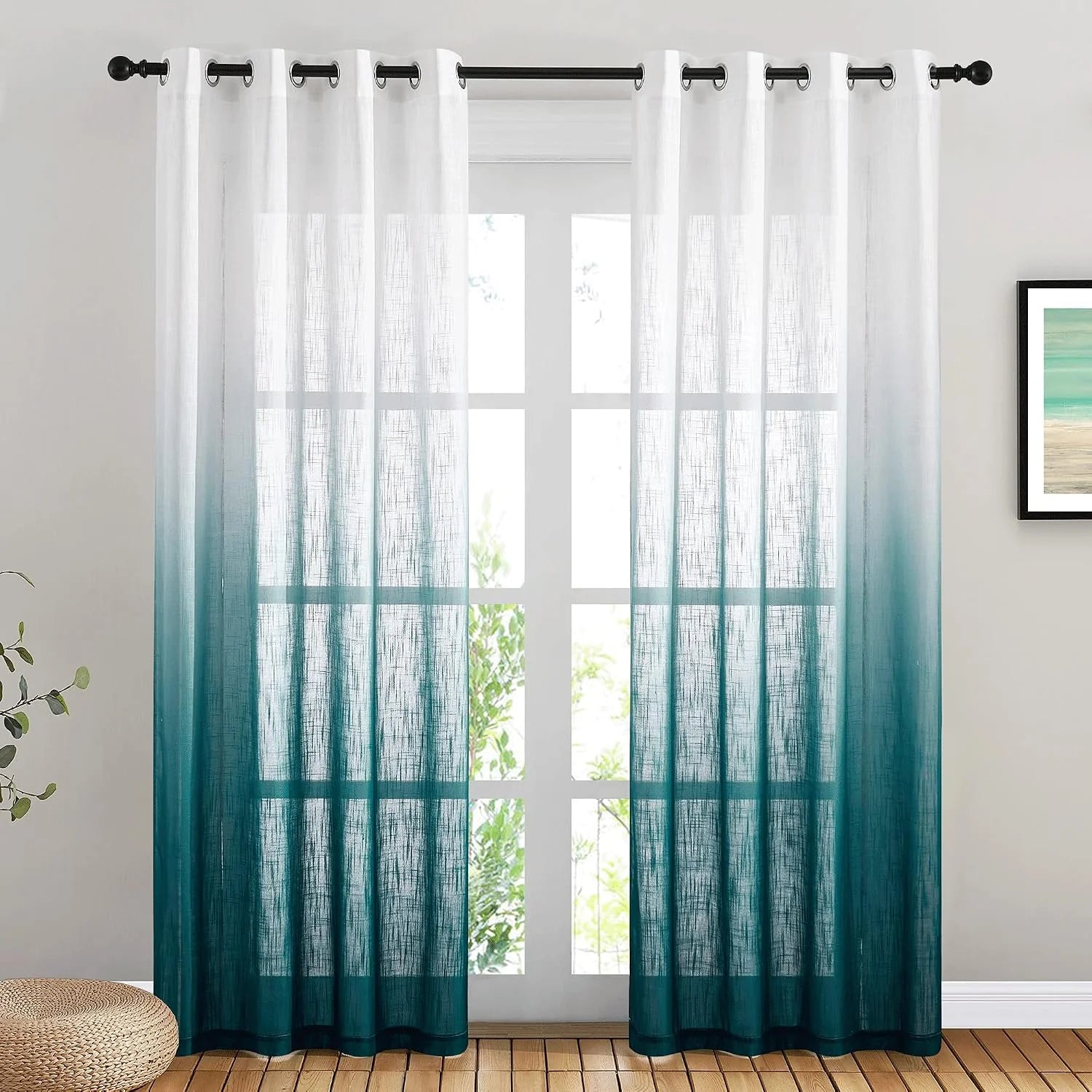 White to teal ombre sheer curtains with grommet top hanging on a black rod