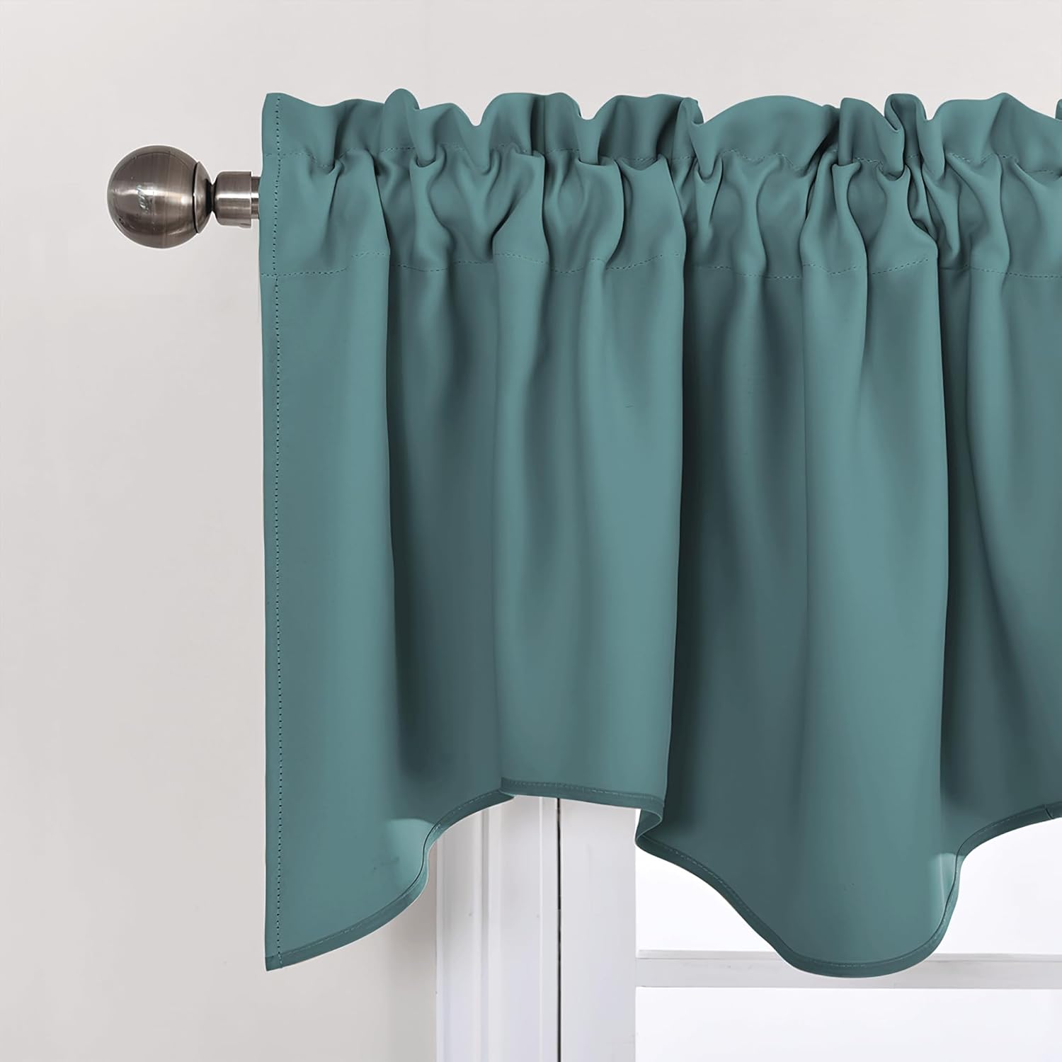 Deep teal rod pocket window valance with ruffled top and scalloped edge on a bronze rod.