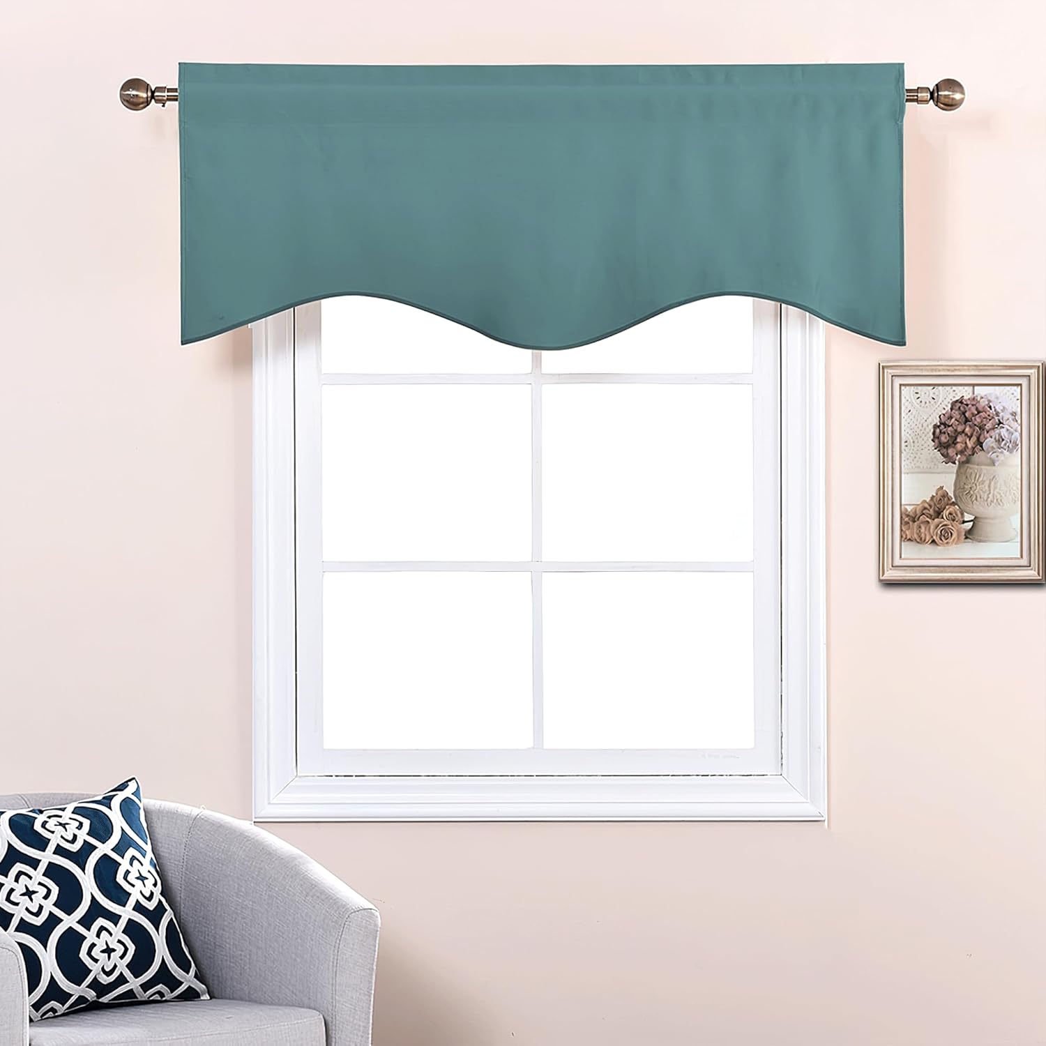 Teal blue scalloped window valance draped over a white window frame on a bronze rod.