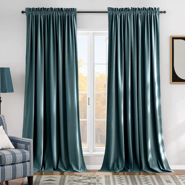 Pair of dark teal velvet rod pocket blackout curtains beautifully frame a bright window.