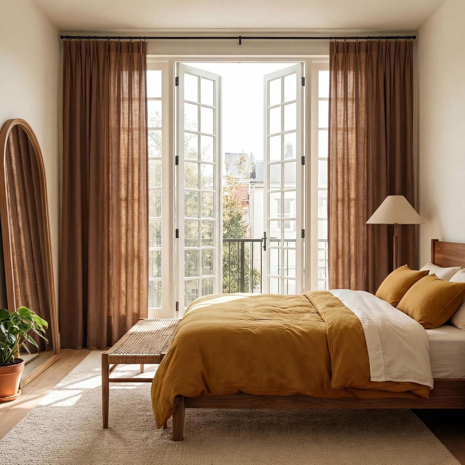 Terracotta linen pleated light filtering curtains framing bright french doors in a sunlit bedroom.