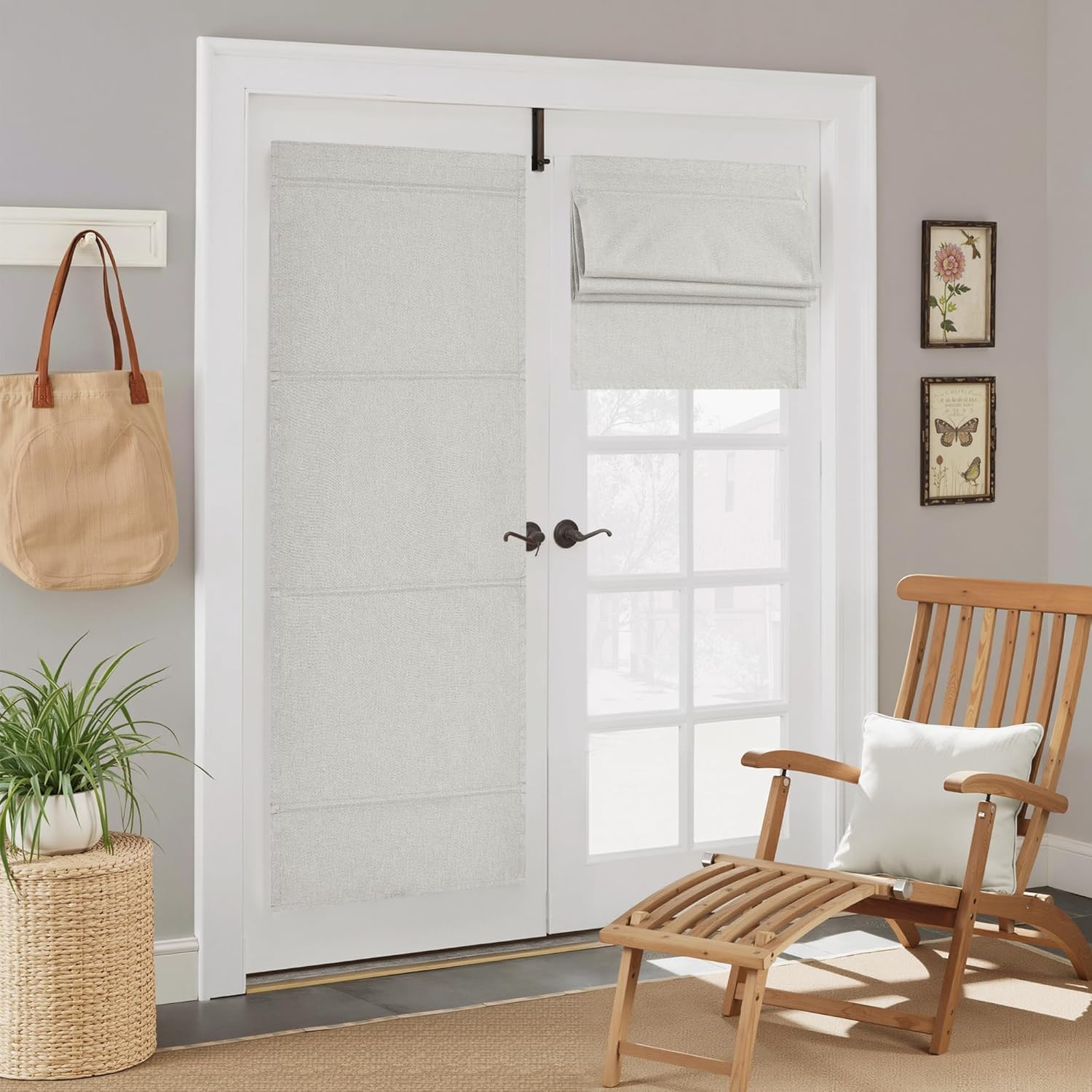 Textured light grey roman shades on white French doors. One fully extended, the other partially folded.