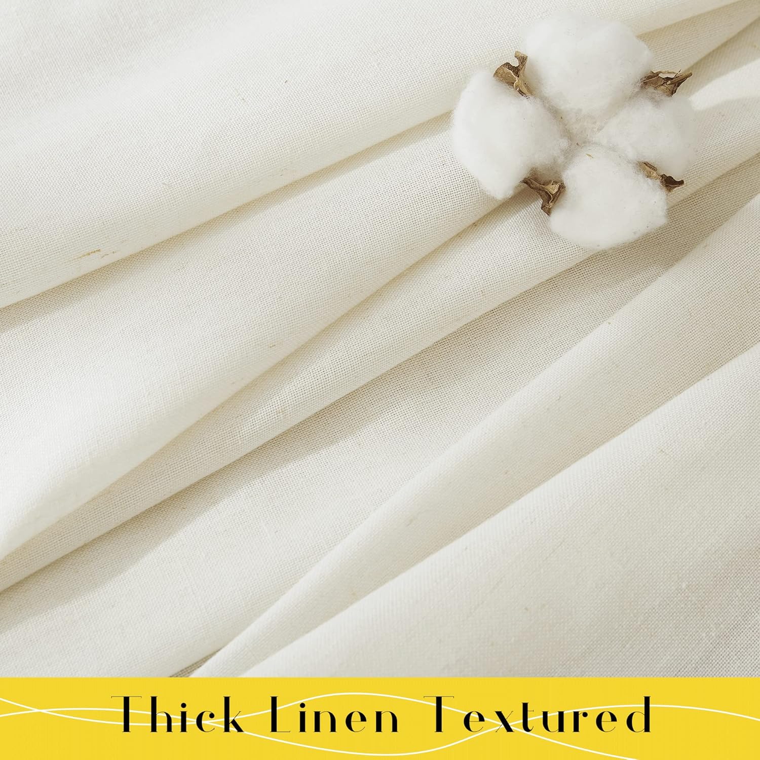 Close-up of thick cream linen textured fabric, folded to reveal its natural weave, with a cotton boll placed on top.